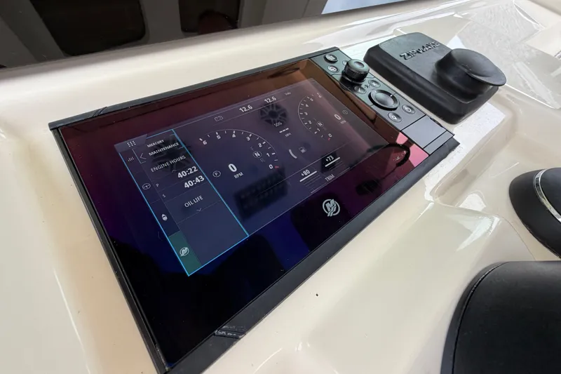 Slide: The Image of 2026 Scout 330 LXF boat dashboard with digital display and controls. - 40