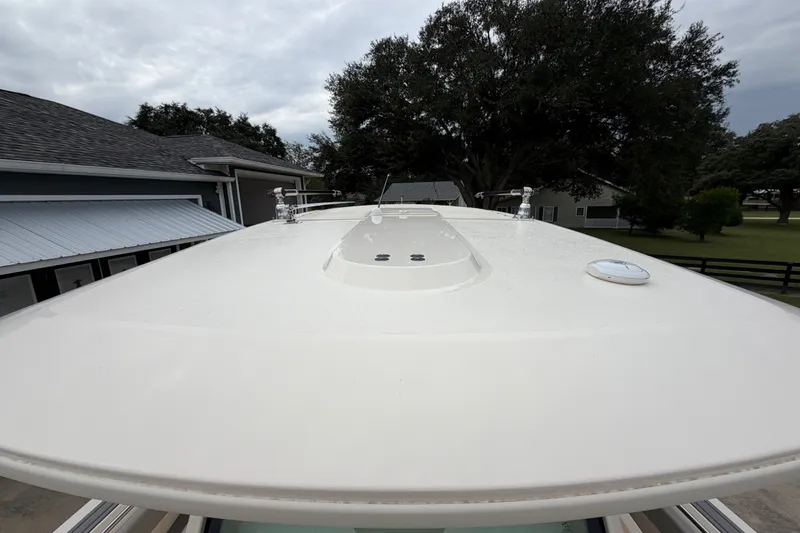 Slide: The Image of Rooftop view of 2026 Scout 330 LXF boat, showcasing sleek design and outdoor setting. - 45