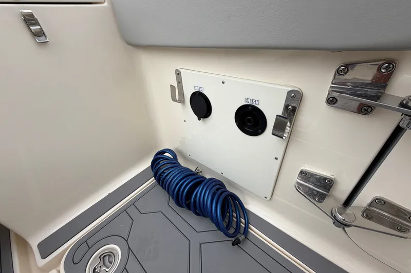 Slide: The Image of 2026 Scout 330 LXF boat deck with hose and water outlets. - 33