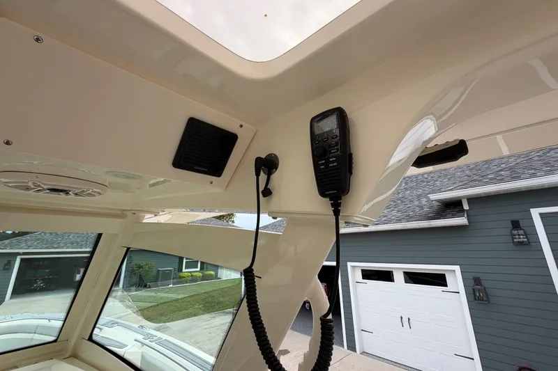 Slide: The Image of Interior view of 2026 Scout 330 LXF boat with communication equipment and speaker. - 39