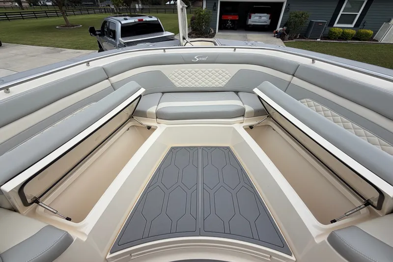 Slide: The Image of 2026 Scout 330 LXF boat interior with cushioned seating and storage compartments. - 19