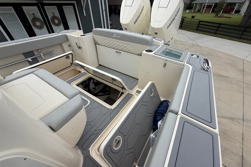 Slide: The Image of 2026 Scout 330 LXF boat interior with seating, storage, and Mercury engines. - 23