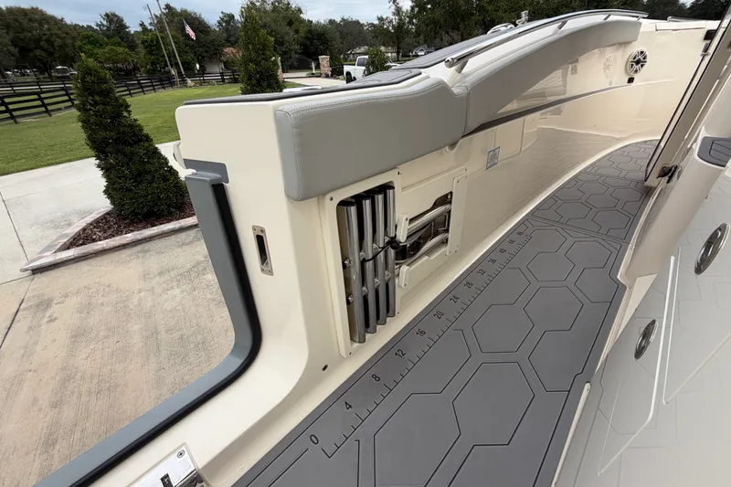 Slide: The Image of 2026 Scout 330 LXF boat interior with hexagonal patterned flooring and sleek seating. - 32