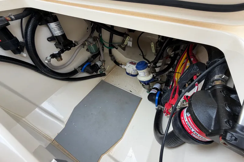 Slide: The Image of Engine compartment of 2026 Scout 330 LXF boat, showcasing wiring and mechanical components. - 44