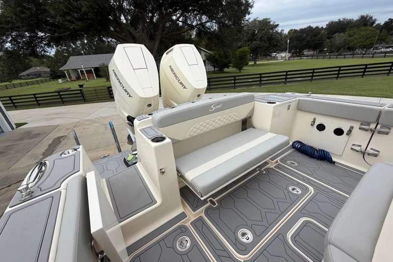 Slide: The Image of 2026 Scout 330 LXF boat interior with dual Mercury engines, luxurious seating, and modern design. - 15