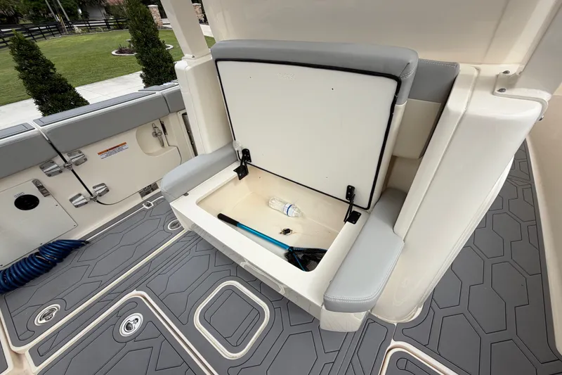 Slide: The Image of 2026 Scout 330 LXF boat interior with open storage compartment and seating. - 31