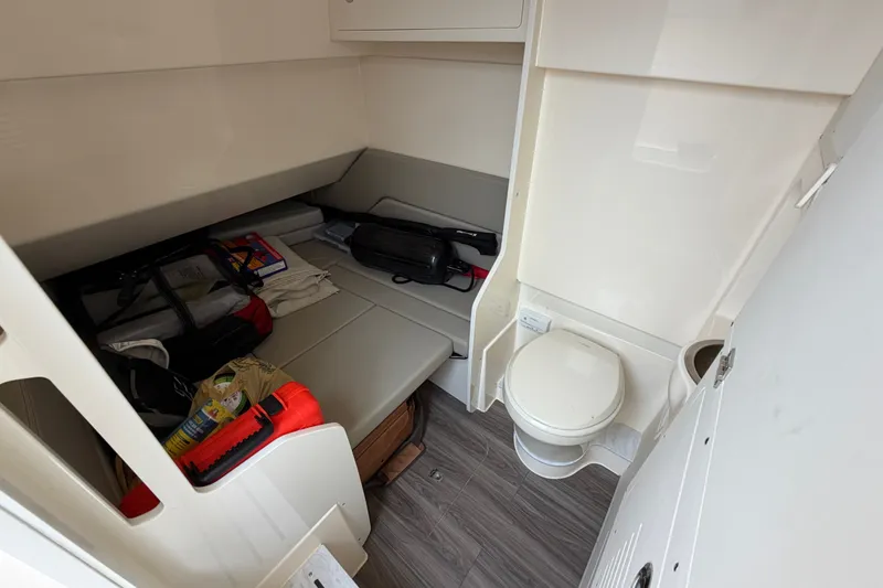 Slide: The Image of Interior cabin of 2026 Scout 330 LXF boat with seating and toilet. - 42