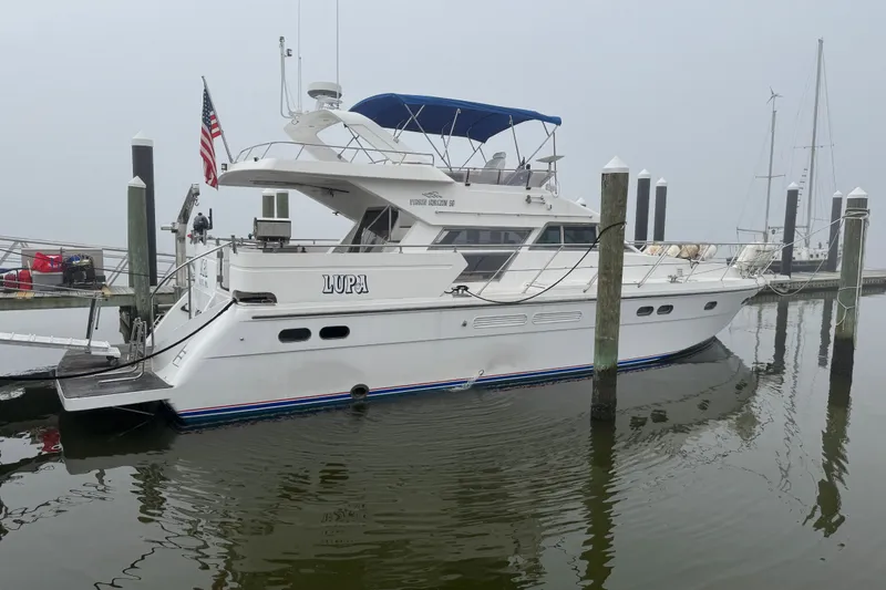 The Image of A 2001 Horizon Virgin yacht named "Lupa" docked at a marina on a foggy day. - 0