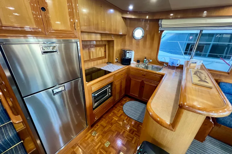 Slide: The Image of Luxurious kitchen interior of 2000 Ocean Alexander 430 Classicco yacht with wood finish. - 13