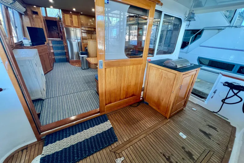 Slide: The Image of Interior view of 2000 Ocean Alexander 430 Classicco yacht with wooden finishes and modern amenities. - 5