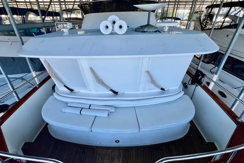 Slide: The Image of 2000 Ocean Alexander 430 Classicco yacht with white seating and deck, docked in a marina. - 45