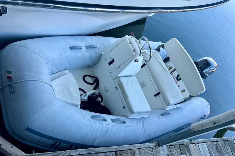 Slide: The Image of Inflatable boat docked beside Ocean Alexander 430 Classicco, 2000 model, on calm water. - 68