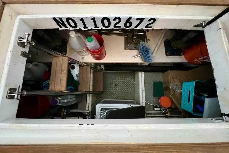Slide: The Image of Storage compartment on a 2000 Ocean Alexander 430 Classicco, containing cleaning supplies and tools. - 64