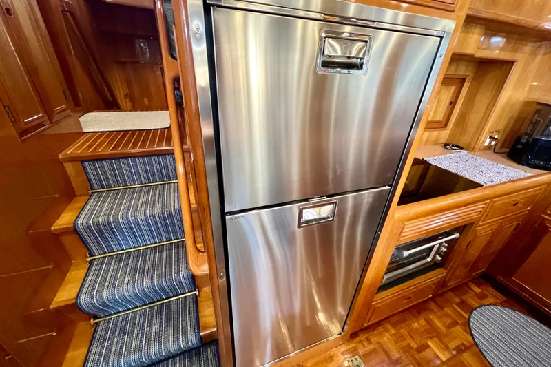 Slide: The Image of Luxurious Ocean Alexander 430 Classicco yacht interior with stainless steel fridge and wooden cabinetry. - 18