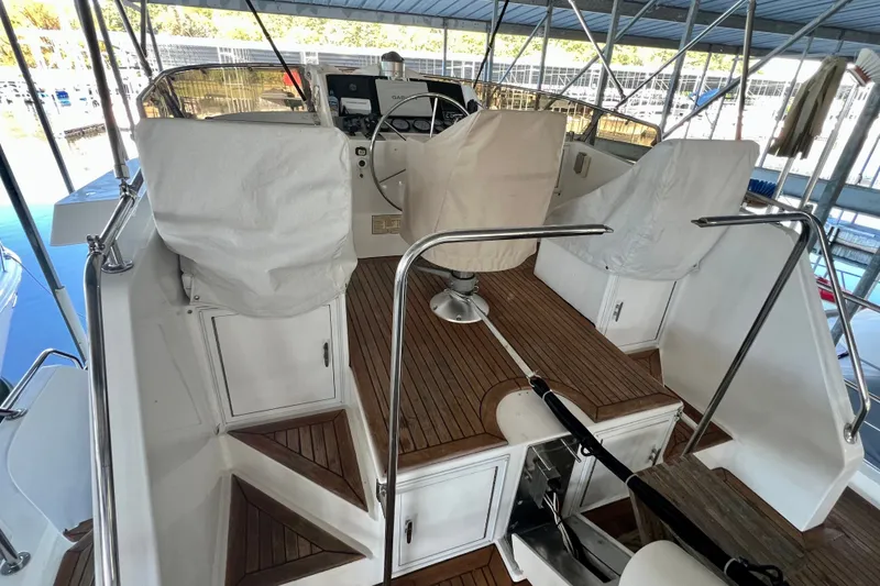 Slide: The Image of Covered helm area of 2000 Ocean Alexander 430 Classicco yacht with wooden deck. - 52