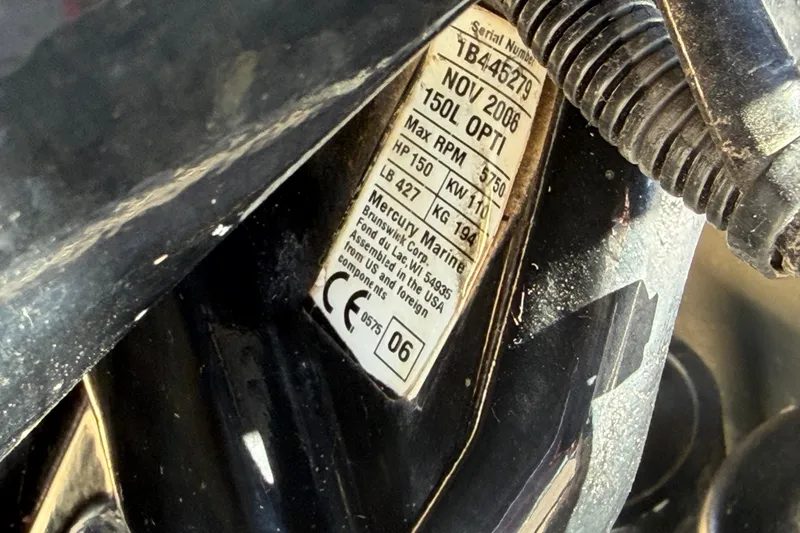 Slide: The Image of Label on a 2003 Tracker Tournament V-18 boat engine, showing specifications and serial number. - 19