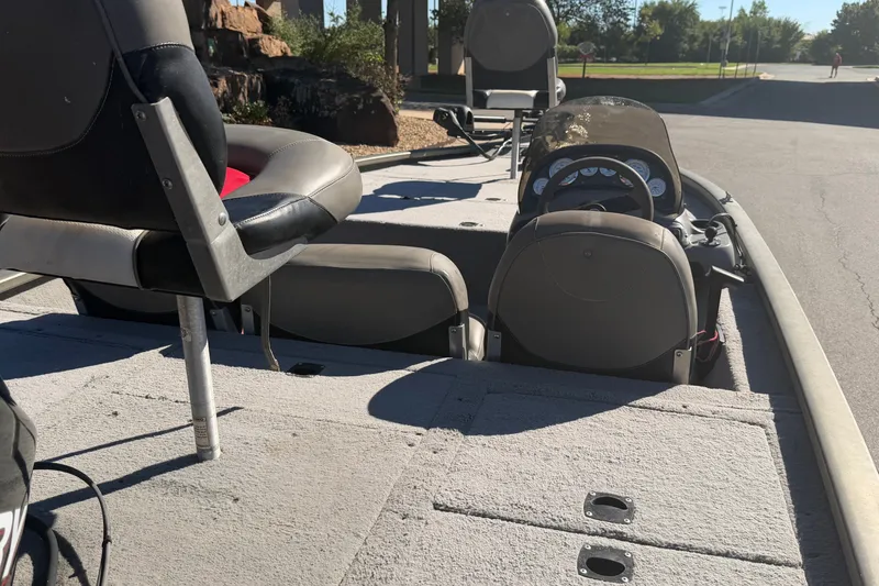 Slide: The Image of 2003 Tracker Tournament V-18 boat interior with seating and steering console. - 18
