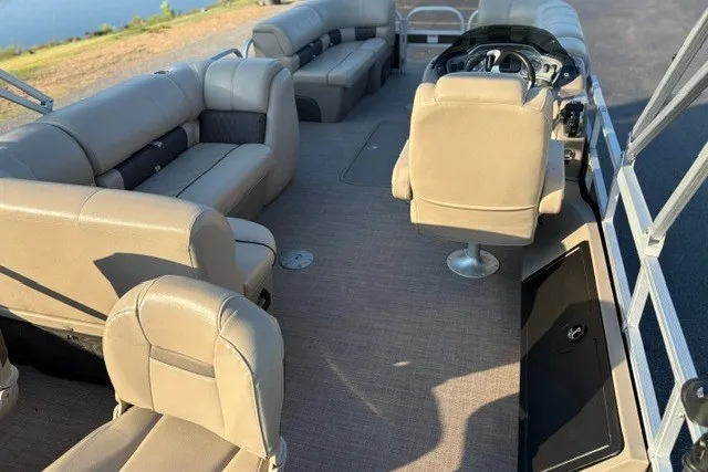 Slide: The Image of 2020 Sun Tracker SportFish 22 XP3 pontoon boat interior with beige seating and steering console. - 52