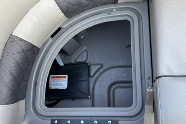 Slide: The Image of Storage compartment in 2020 Sun Tracker SportFish 22 XP3 boat with cushioned seating. - 25