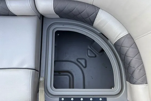 Slide: The Image of Storage compartment on a 2020 Sun Tracker SportFish 22 XP3 boat with cushioned seating. - 26