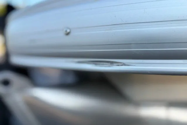 Slide: The Image of Close-up of a 2020 Sun Tracker SportFish 22 XP3 boat with minor hull damage. - 18