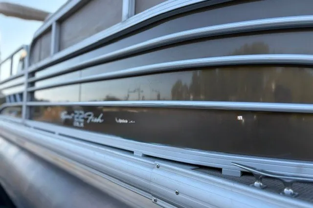 Slide: The Image of 2020 Sun Tracker SportFish 22 XP3 pontoon boat side view with sleek metallic finish. - 15