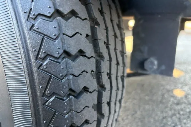 Slide: The Image of Close-up of a 2020 Sun Tracker SportFish 22 XP3 tire tread pattern. - 58