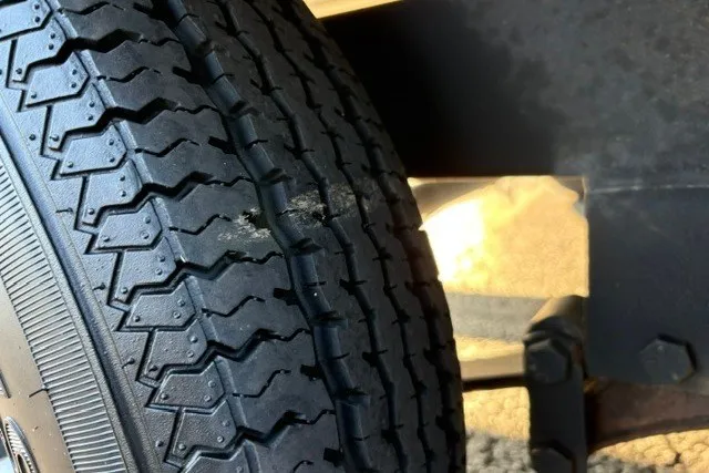 Slide: The Image of Close-up of a worn tire on a 2020 Sun Tracker SportFish 22 XP3 trailer. - 59