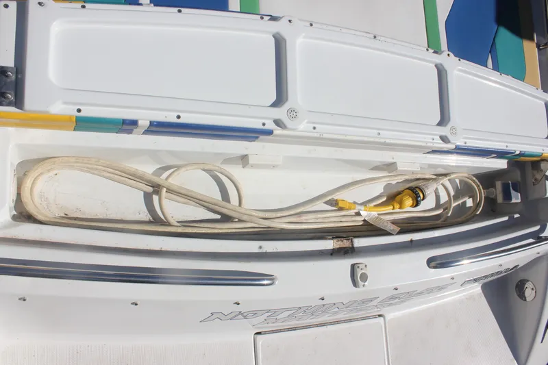 Slide: The Image of Storage compartment on a 2001 Formula 353 FASTech boat with coiled power cable. - 11