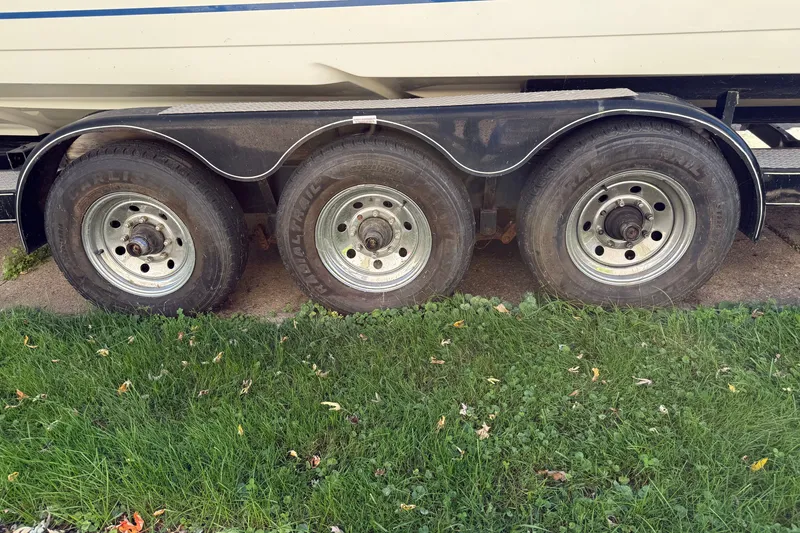 Slide: The Image of Triple-axle trailer with Formula 353 FASTech boat, 2001 model, parked on grass. - 45