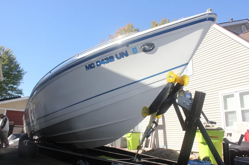 The Image of 2001 Formula 353 FASTech boat on trailer, parked near residential buildings. - 0