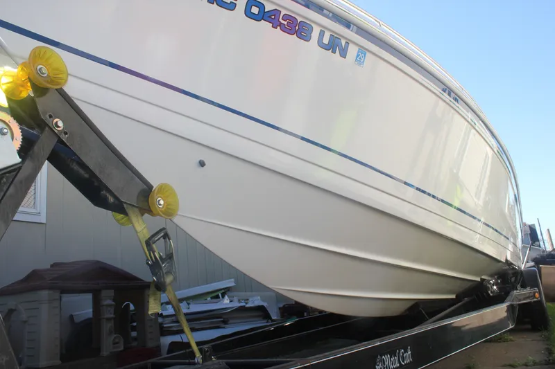 Slide: The Image of 2001 Formula 353 FASTech boat on trailer, side view, white hull with blue accents. - 5