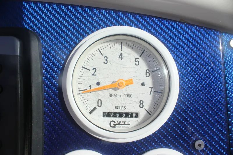 Slide: The Image of Tachometer on 2001 Formula 353 FASTech boat dashboard with blue carbon fiber background. - 16