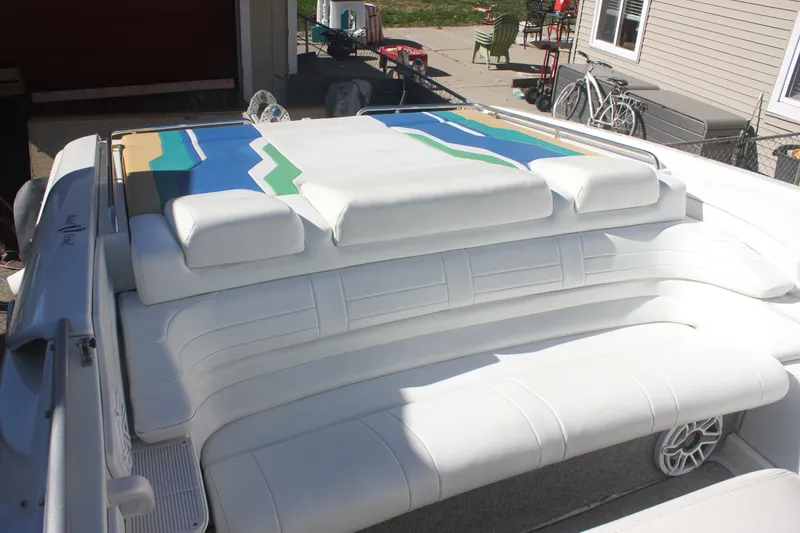 Slide: The Image of 2001 Formula 353 FASTech boat with white cushioned seating and colorful deck design. - 21