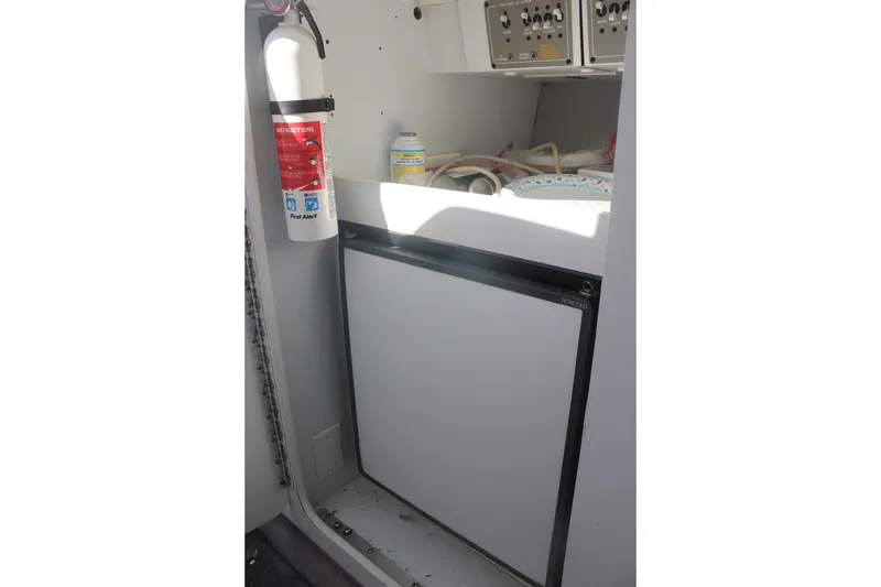 Slide: The Image of 2001 Formula 353 FASTech interior with fire extinguisher and compact refrigerator. - 35