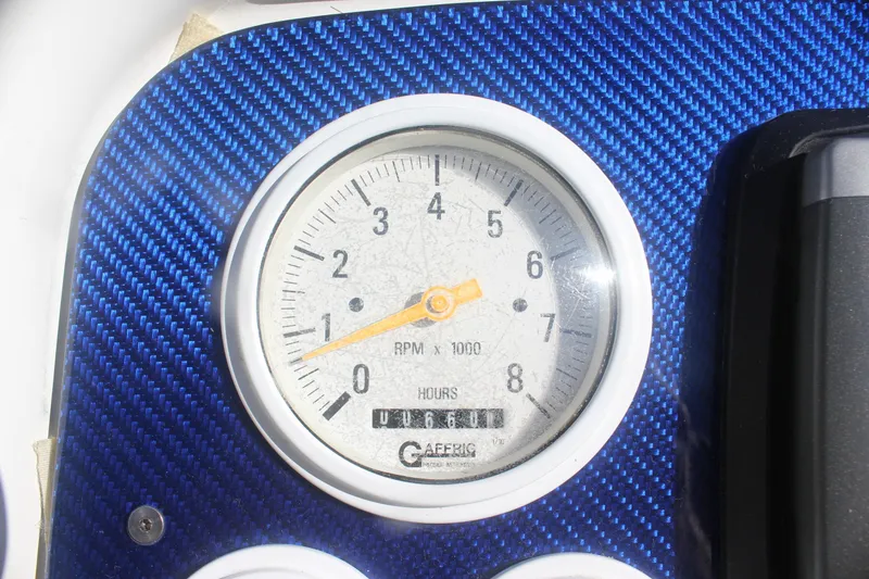 Slide: The Image of Tachometer on 2001 Formula 353 FASTech boat dashboard, blue carbon fiber background. - 15