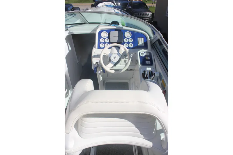 Slide: The Image of Cockpit of a 2001 Formula 353 FASTech boat with white seating and control panel. - 13