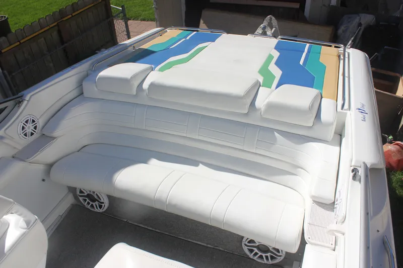 Slide: The Image of 2001 Formula 353 FASTech boat with white seating and colorful deck design. - 22