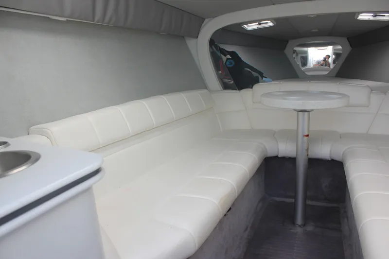 Slide: The Image of Interior of a 2001 Formula 353 FASTech boat with white seating and table. - 29