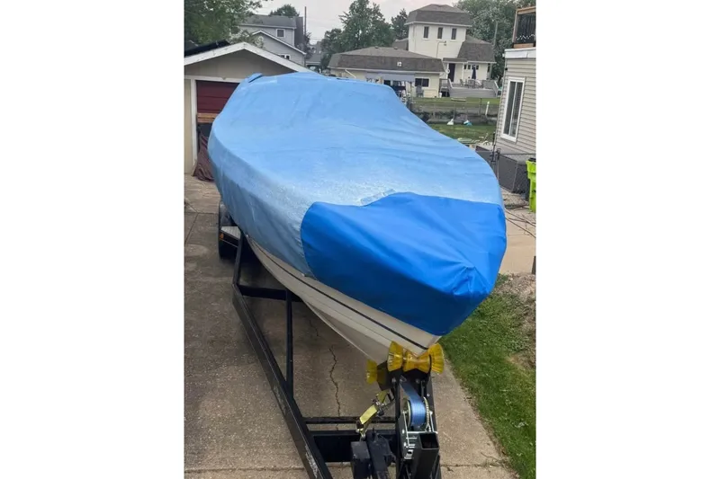 Slide: The Image of 2001 Formula 353 FASTech boat covered with blue tarp on trailer in residential area. - 48