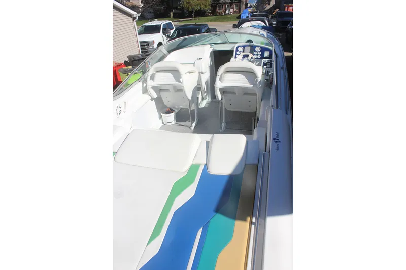 Slide: The Image of 2001 Formula 353 FASTech boat interior with white seating and colorful deck design. - 9