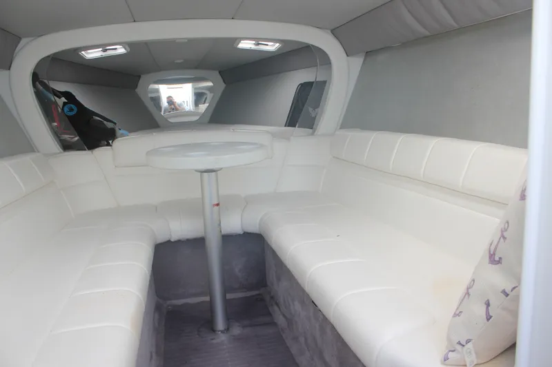 Slide: The Image of Interior of a 2001 Formula 353 FASTech boat with white seating and table. - 28