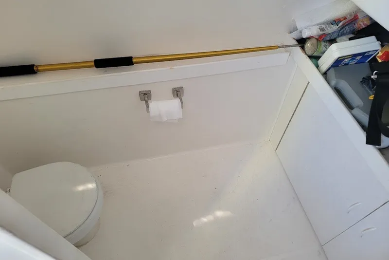 Slide: The Image of 2004 Stamas 310 Tarpon boat interior with toilet and storage area. - 9