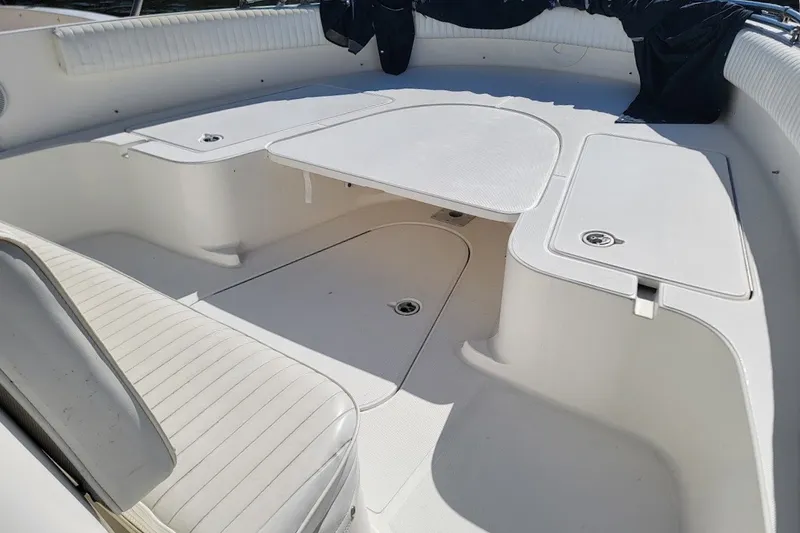 Slide: The Image of 2004 Stamas 310 Tarpon boat interior with white seating and storage compartments. - 14