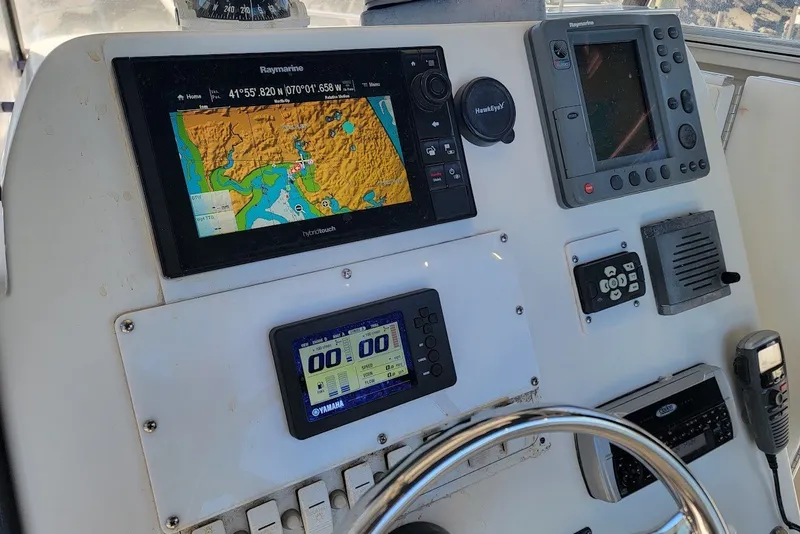 Slide: The Image of Control panel of a 2004 Stamas 310 Tarpon boat with navigation and communication equipment. - 3
