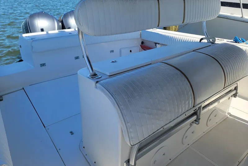 Slide: The Image of 2004 Stamas 310 Tarpon boat interior with seating and dual engines visible. - 20