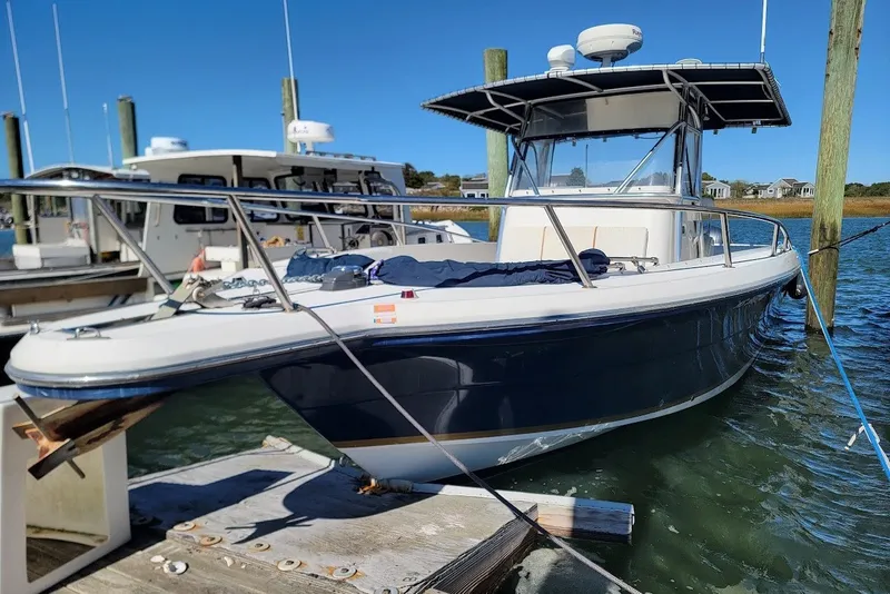 Slide: The Image of 2004 Stamas 310 Tarpon boat docked at marina, featuring sleek design and sturdy build. - 29