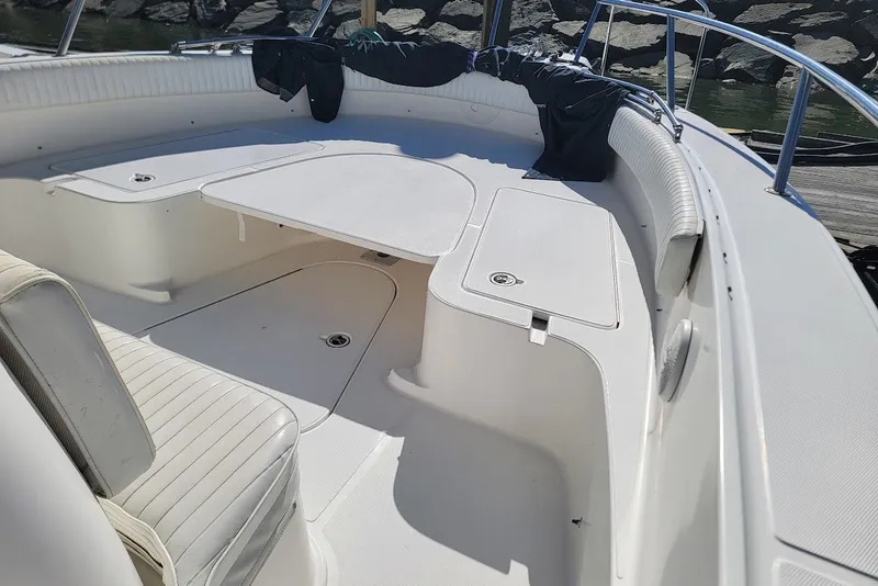 Slide: The Image of 2004 Stamas 310 Tarpon boat interior with white seating and storage compartments. - 27