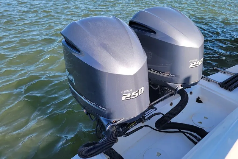 Slide: The Image of Twin Yamaha 250 outboard engines on a 2004 Stamas 310 Tarpon boat in water. - 5