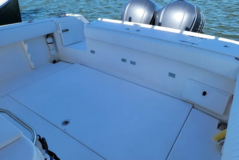 Slide: The Image of 2004 Stamas 310 Tarpon boat deck with twin outboard motors on water. - 24